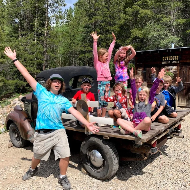 a group of kids posing for the camera with country boy mine in breckenridge, colorado