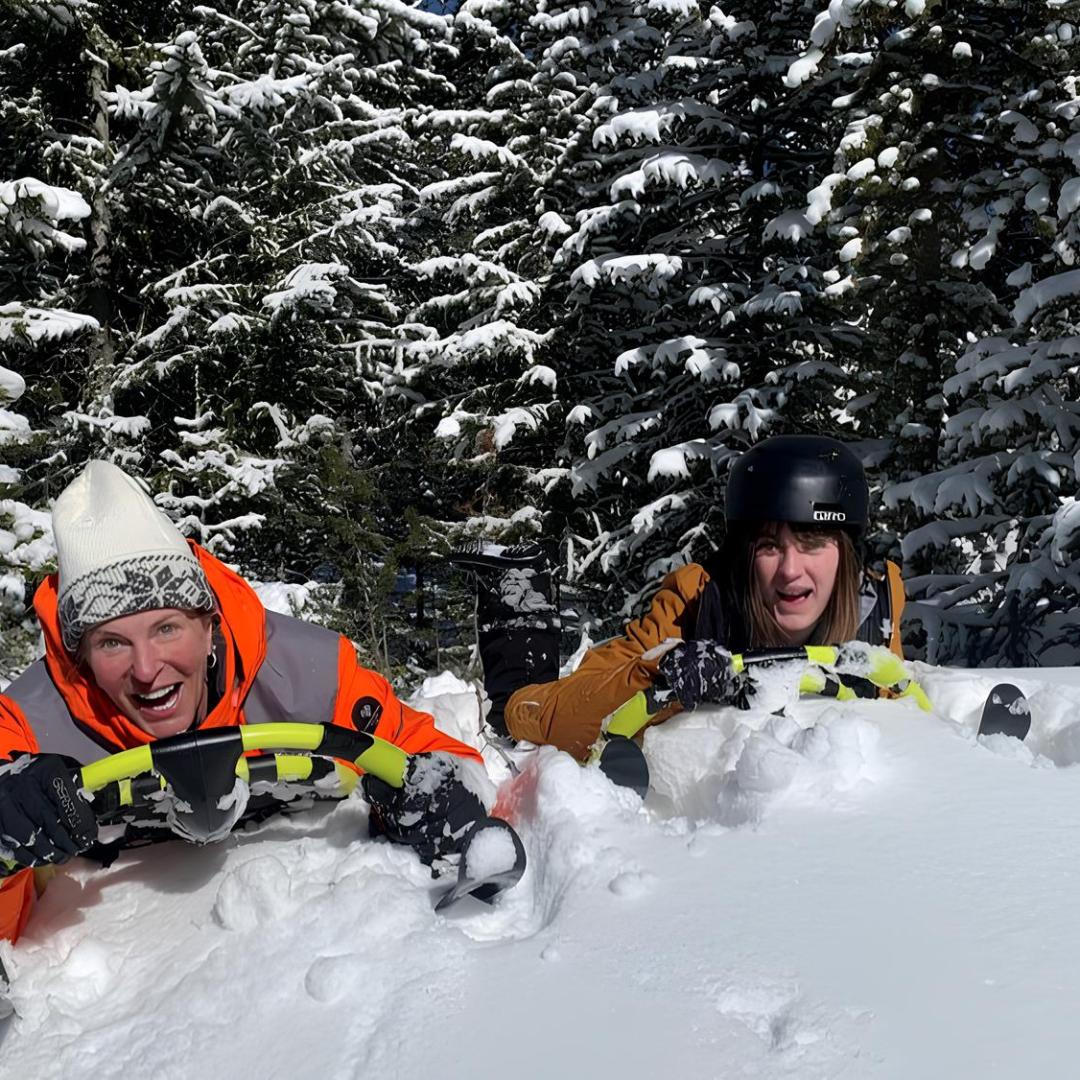 two women extreme sledding with country boy mine in breckenridge, colorado
