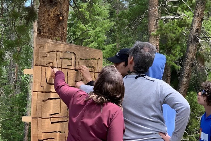 a family looking at a map on a private treasure hunt tour with country boy mine in breckenridge, colorado